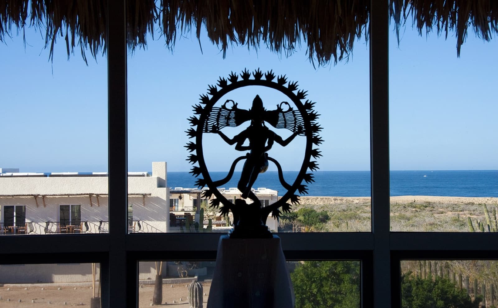 Nataraja statue framing the Pacific
